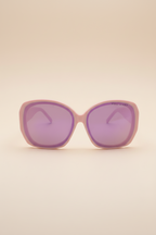 Front view of Sol Kyst oversized sunglasses with, pink acetate frames, and purple nylon lenses.