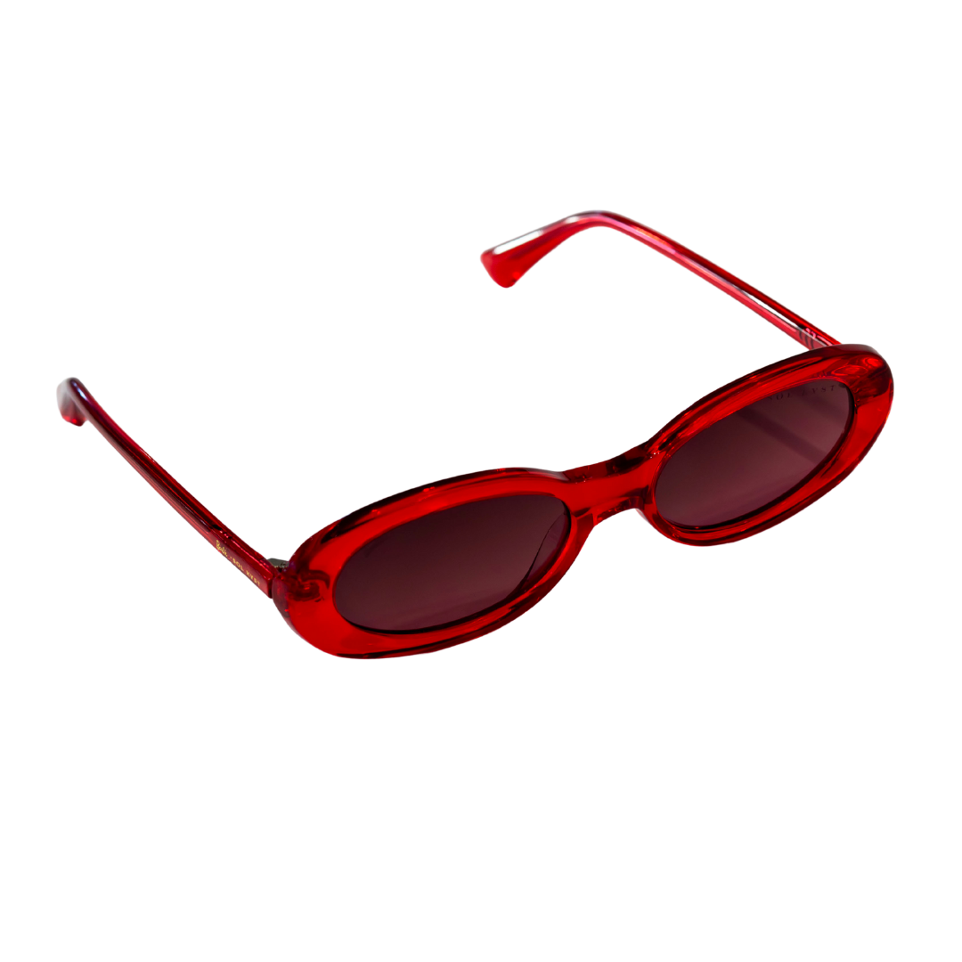 Side angle of Barbie x Sol Kyst oval sunglasses with tinted lenses and sleek red frame design