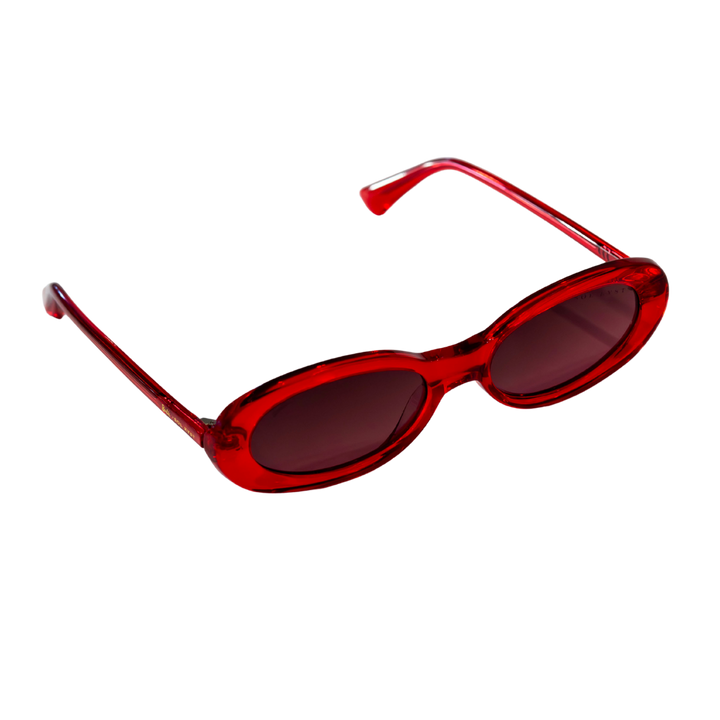 Side angle of Barbie x Sol Kyst oval sunglasses with tinted lenses and sleek red frame design