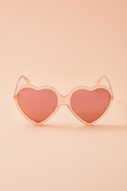 Peach-pink heart-shaped sunglasses with nylon lenses from the Barbie x Sol Kyst collection.