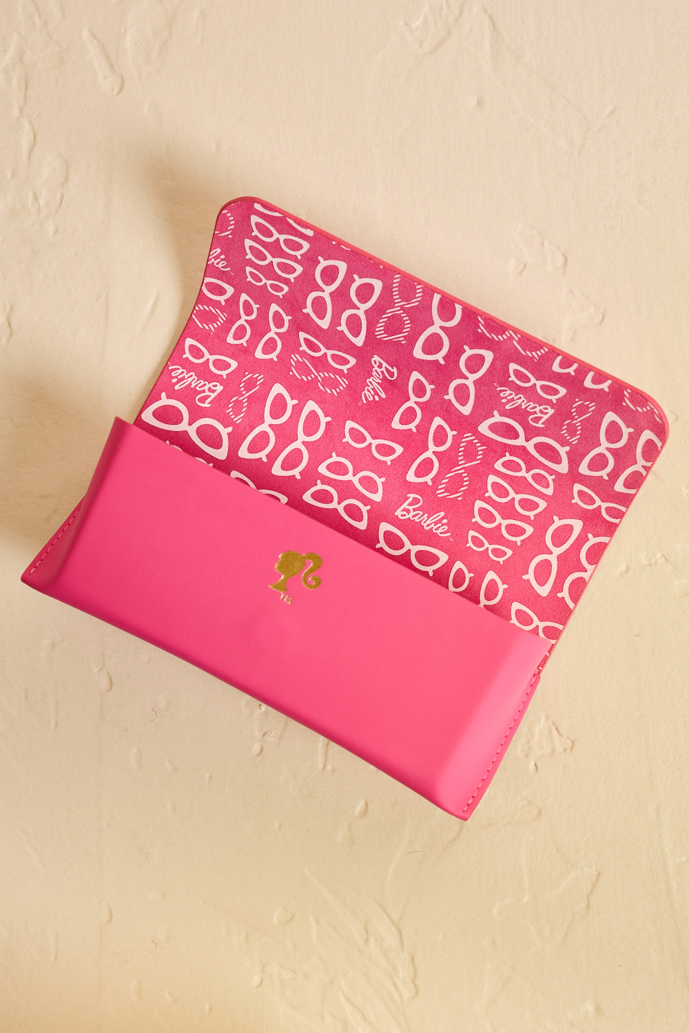 Pink Barbie sunglasses case open, showing interior design - top view