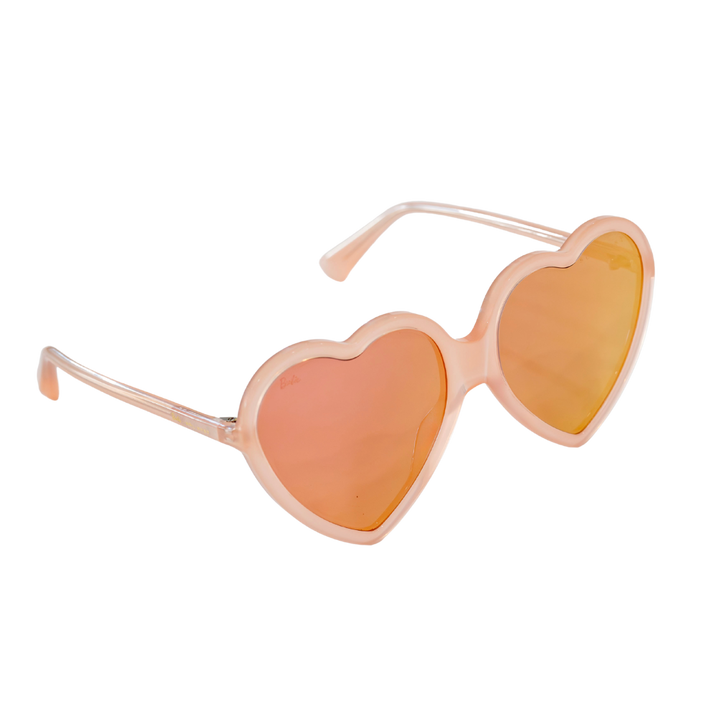 Side angle of peach-pink Barbie x Sol Kyst heart-shaped sunglasses with reflective pink-tinted lenses.