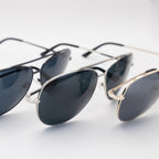 Close-up of three Sol Kyst women's aviator sunglasses in black, silver, and gold frames with dark polarized lenses, arranged on a white surface.