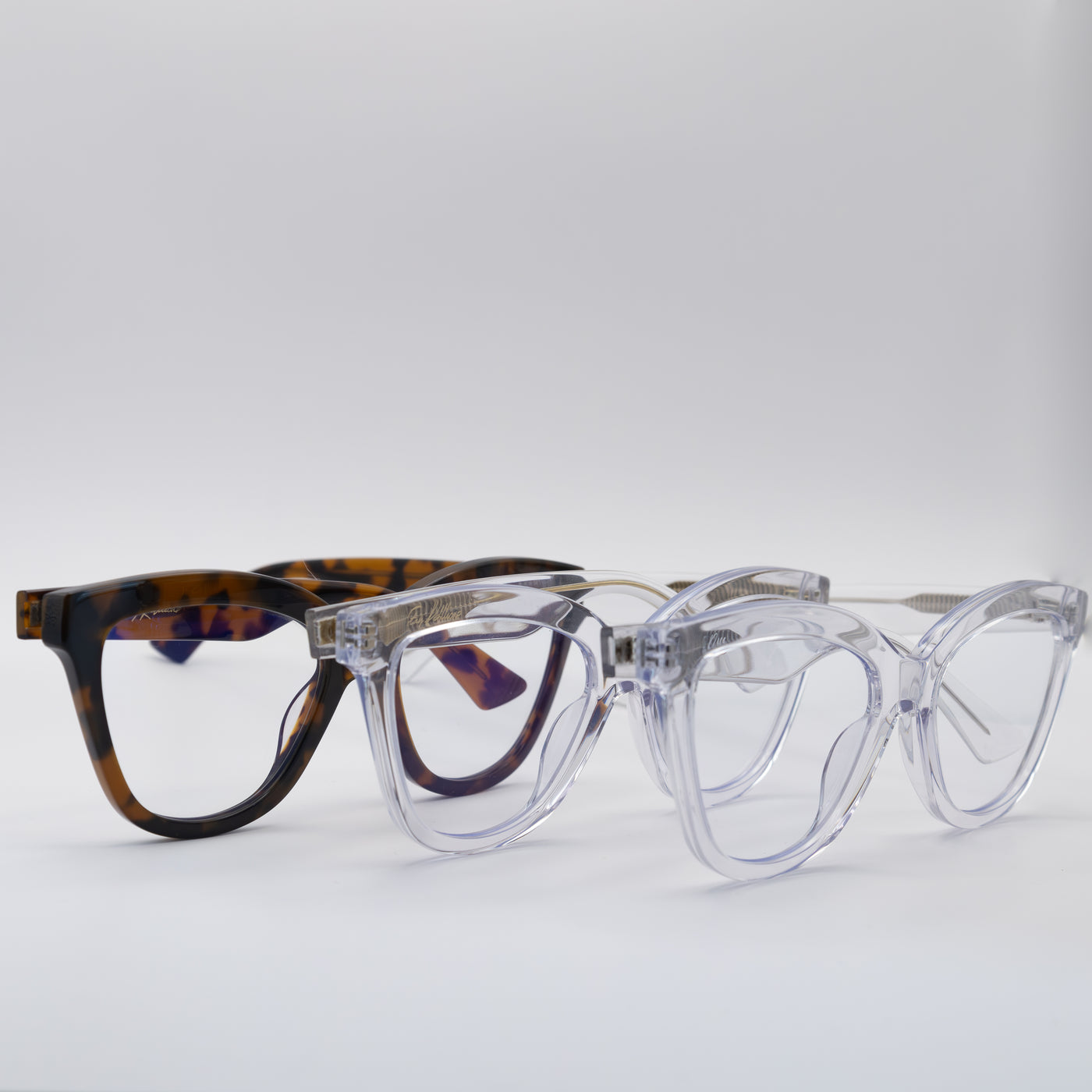 Three women's blue light glasses with various frame colours and clear lenses.