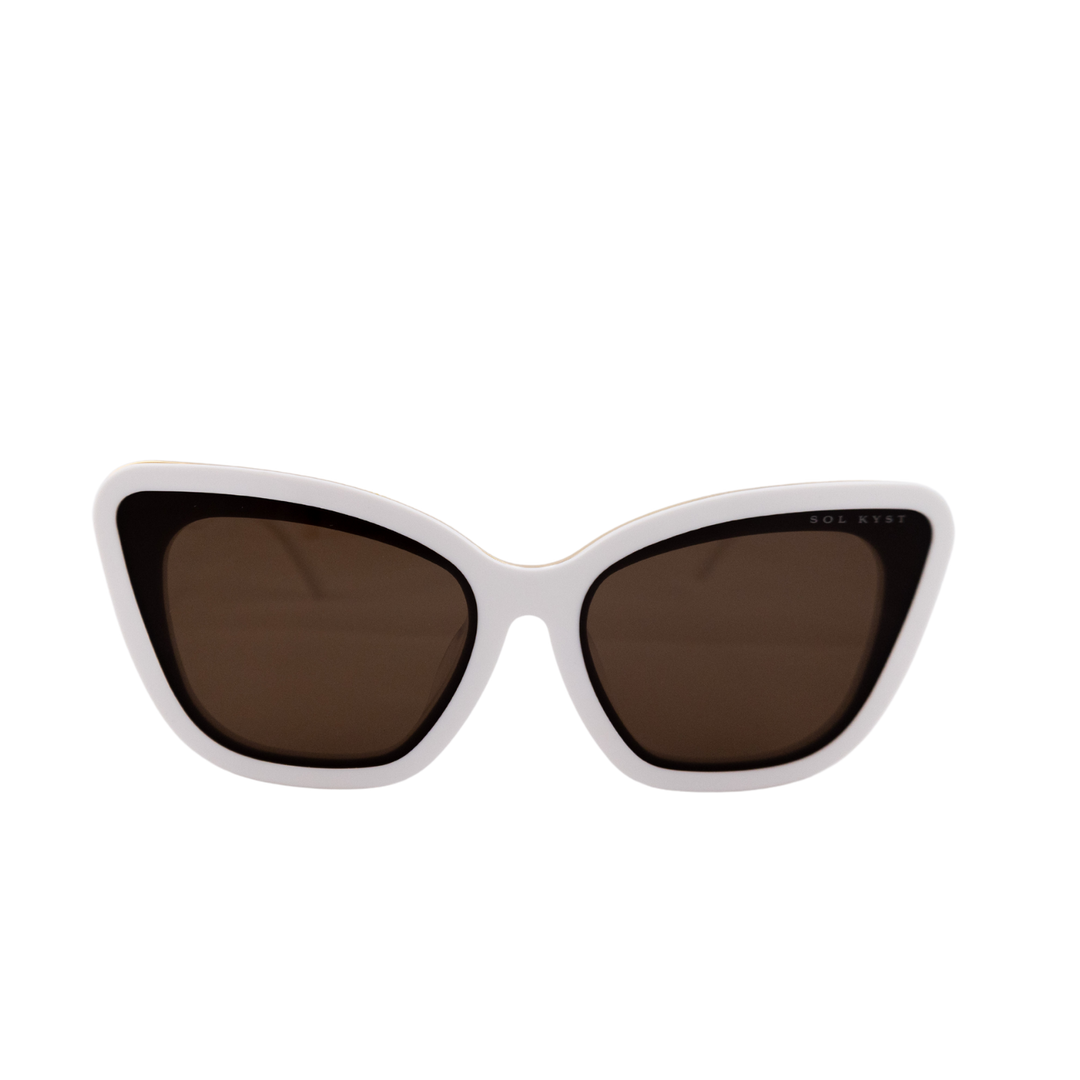 Close-up view of Sol Kyst Bridal Collection sunglasses featuring a white acetate frame and soft square cat-eye design with brown lenses.
