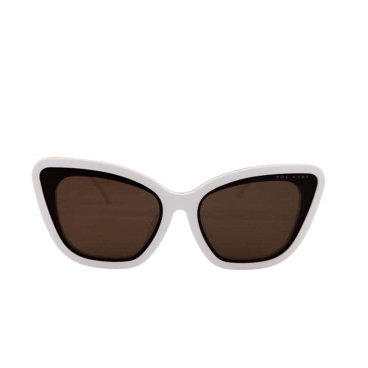 Close-up view of Sol Kyst Bridal Collection sunglasses featuring a white acetate frame and soft square cat-eye design with brown lenses.