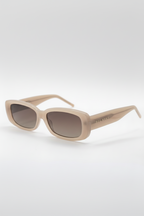 Beige sunglasses with a brand logo on a white background