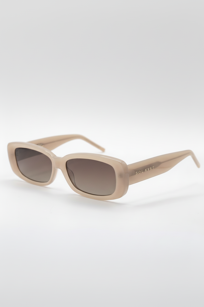 Beige sunglasses with a brand logo on a white background