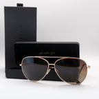 Rose gold women's aviator sunglasses in front of case and product box.