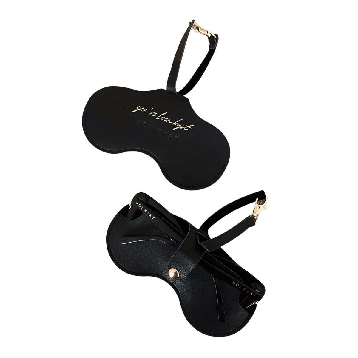 Two views of the black Sol Kyst Kyst Klip, one with 'you’ve been kyst' gold lettering and another holding sunglasses.