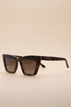 Four angles of women's trapezoid sunglasses with tortoise frame and gradient lenses.
