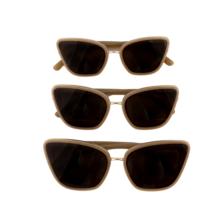 Front view of three Sol Kyst women's cat eye sunglasses, stacked vertically with beige frames and dark lenses.