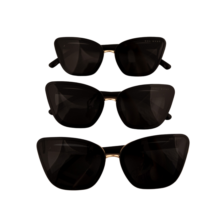 Three pairs of black Sol Kyst cat eye sunglasses with dark tinted lenses - arranged in a column.
