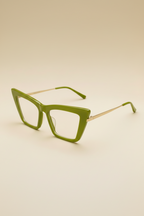 Green cat-eye glasses on a beige background