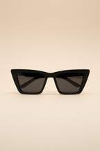 Black cat-eye sunglasses on a beige background